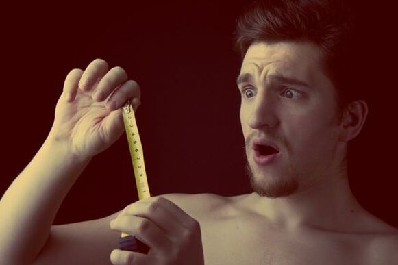 Man measuring penis size before enlargement surgery